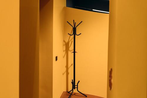 a black pole in the corner of a room at [Private Parking] centro storico: l'affresco in Bologna