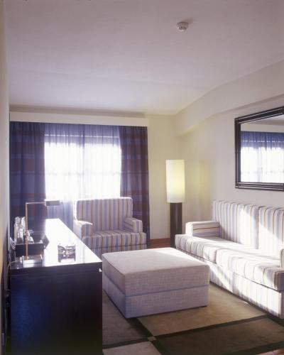 a living room with a couch and two chairs and a table at Pousada Forte da Horta in Horta