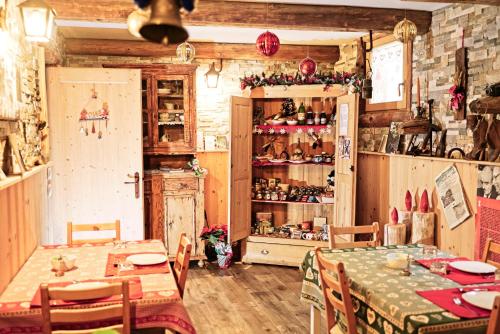a dining room with a table and a shelf with dishes at B&B Ai Marchetini in Cinte Tesino