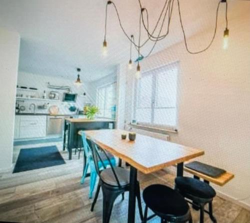a kitchen with a table and chairs in a room at Wohnung in idyllischer Lage auf Borkum in Borkum