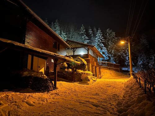 a house in the snow at night at Ubytovanie Privat Antoni - apartmán v RD in Tvrdošín