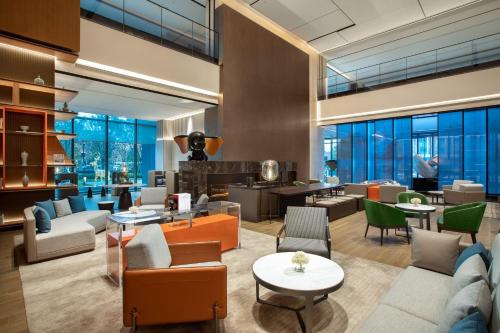 a lobby of a hotel with chairs and tables at Crowne Plaza Zhengzhou High Tech Zone by IHG in Zhengzhou