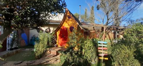 a house with a colorful roof with a garden at Mini House Park in Campo Alegre