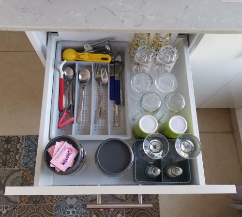 a drawer filled with utensils and other kitchen items at נופש מול הכנרת Vacation in front of the Sea Galilee in Tiberias