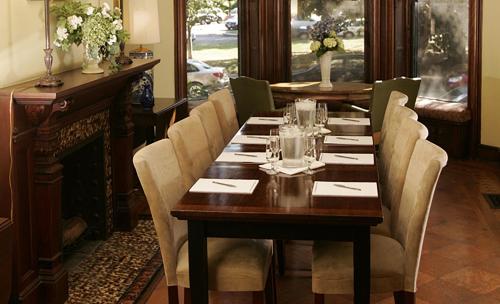 a dining room with a wooden table and chairs at Morgan State House Inn in Albany
