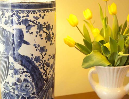 a blue and white vase with yellow flowers in it at Morgan State House Inn in Albany