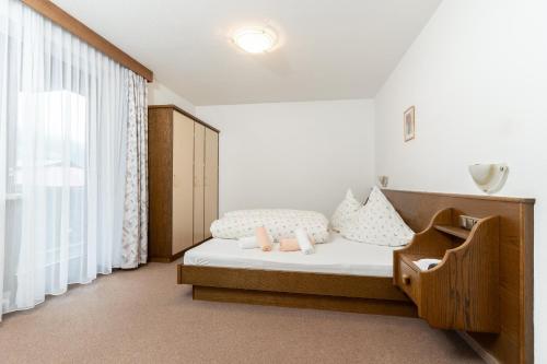 a bedroom with a bed and a large window at Gurglerhof in Sölden