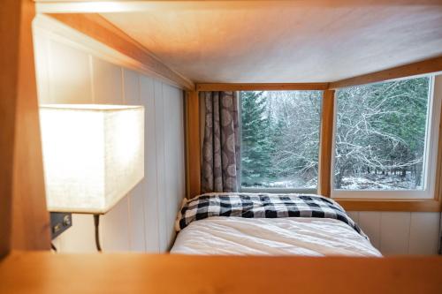 a bed in a small room with a window at Rangeley Lake House, lake access, Saddleback 15min in Rangeley