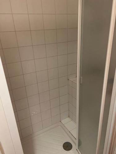 a shower with a glass door in a bathroom at T2 meuble in Oyonnax