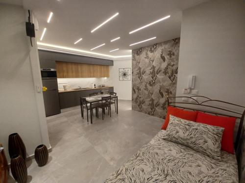 a bedroom with a bed and a kitchen with a table at Top View Apartment in Katerini