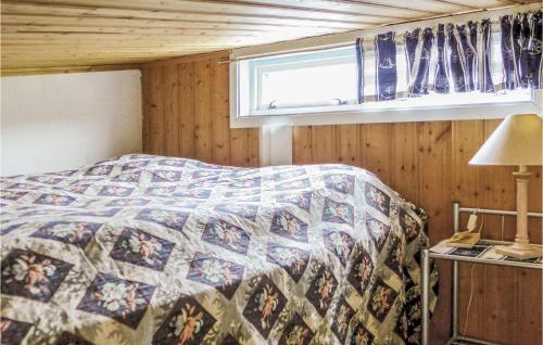 a bedroom with a bed with a quilt on it at Cozy Apartment In Agdenes With House A Mountain View in Selva