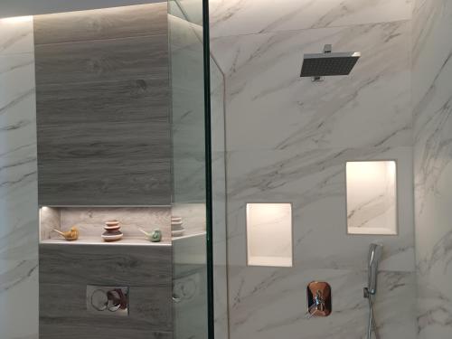 a shower with a glass door in a bathroom at Top View Apartment in Katerini