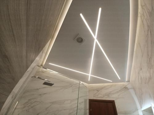 a bathroom with a white ceiling with lights on it at Top View Apartment in Katerini