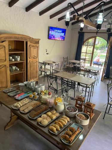 a table with many different types of food on it at Terra Campo Posada in Chacras de Coria