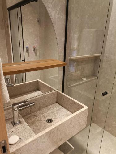 a bathroom with a sink and a shower at Salinas Premium Resort in Salinópolis