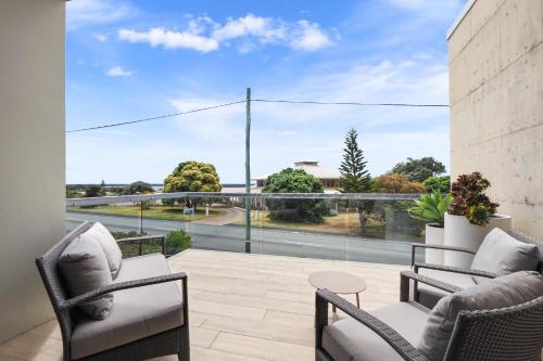 a balcony with chairs and a view of a street at Alouarn Apartments in Augusta