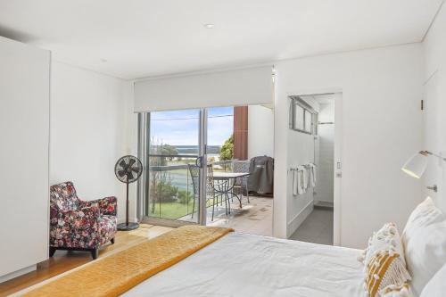 a bedroom with a bed and a balcony at Alouarn Apartments in Augusta