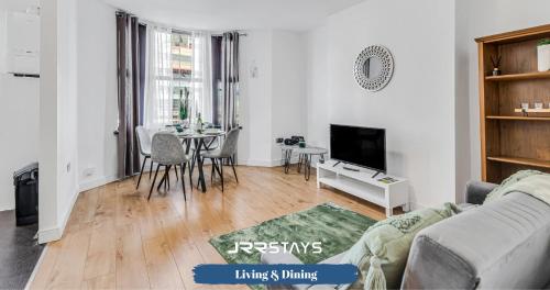 a living room with a couch and a table at Cardiff Stylish 2 Bedroom Sleeps 6 Wi-Fi - JRR Stays in Cardiff