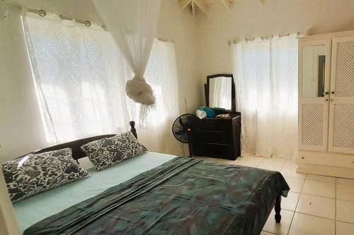 una camera da letto con un letto con due cuscini sopra di StarFish Apartment a Port Elizabeth