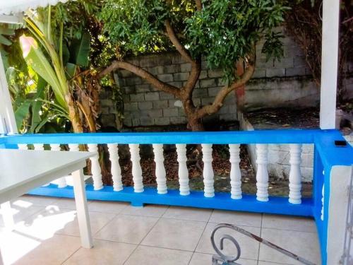 a blue bench sitting in front of a wall at StarFish Apartment in Port Elizabeth