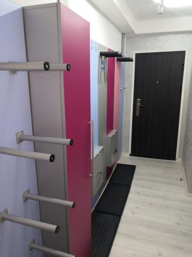 a locker room with a pink door and a hallway at Maja Lux Apartman Brzece in Brzeće