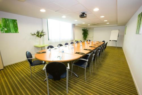 a large conference room with a long table and chairs at All Suites Appart Hôtel - Bordeaux Lac in Bordeaux