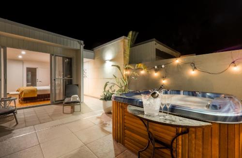 a large bathroom with a tub and a table at Alouarn Apartments in Augusta