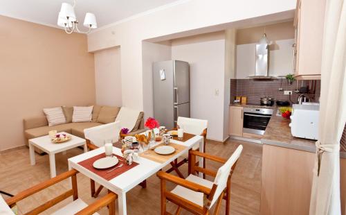 a kitchen and living room with a table and chairs at Calm View in Vasiliki
