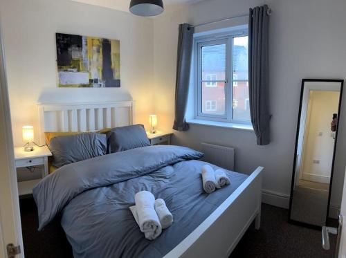 a bedroom with a bed with towels on it at A beautiful house in Rothley in Rothley