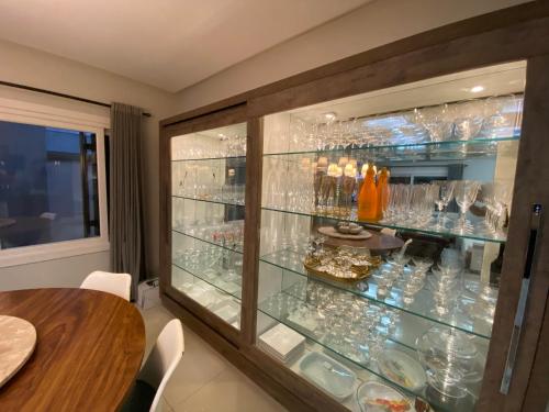 une vitrine en verre dans un restaurant avec une table dans l'établissement Casa com piscina Praia dos Molhes, à Torres