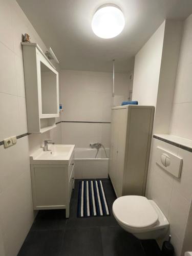 a bathroom with a toilet and a sink and a tub at Studio close from train station and shops in Luxembourg