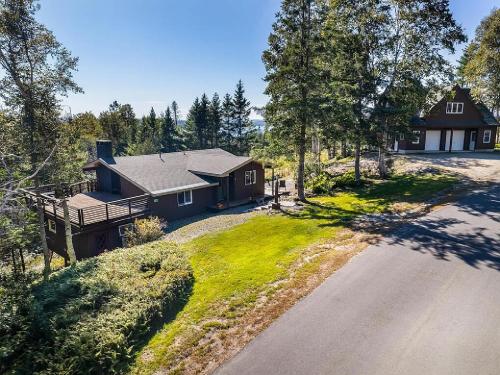an aerial view of a house with a driveway at Rangeley Lake House, lake access, Saddleback 15min in Rangeley