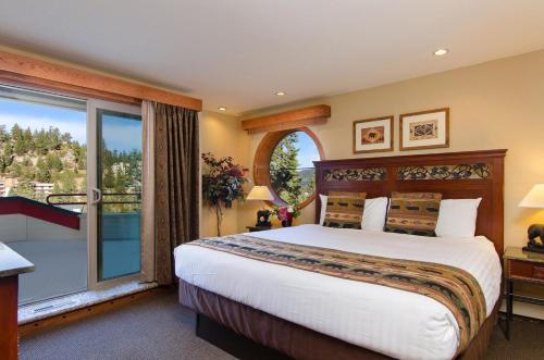 a bedroom with a large bed and a balcony at Holiday Inn Club Vacations - Tahoe Ridge Resort in Stateline