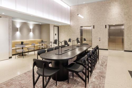 a conference room with a large table and chairs at Veriu Queen Victoria Market in Melbourne
