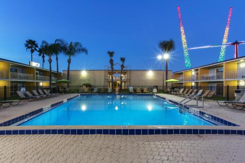 a pool at a hotel at night at Celebration Suites in Orlando
