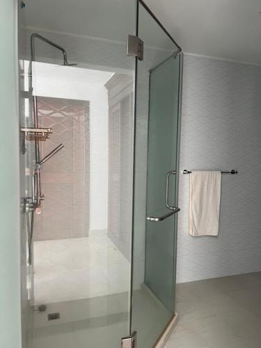 a shower with a glass door in a bathroom at SSK Apartment in Siem Reap