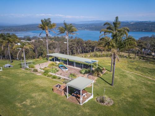 an overhead view of a house on a field with palm trees at Norfolk Pines Motel in Merimbula