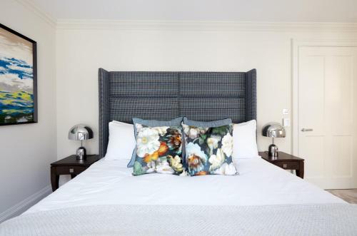 a bedroom with a white bed with two pillows at Luxurious Covent Garden Penthouse in London