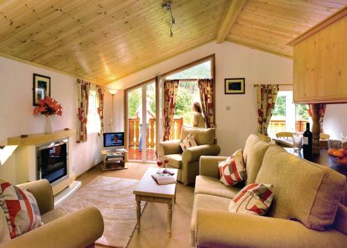 a living room with couches and a fireplace at Angecroft Park in Ettrick