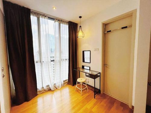 a living room with a desk and a large window at PROMO Connected train 2 Bedroom (ABOVE MALL) 20 in Kuala Lumpur