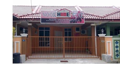 a house with a sign that reads noor home at Homestay Ira Jaya - 4 Unit Rumah in Kangar