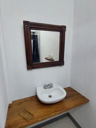 a bathroom with a white sink and a mirror at Terraza Catedral Hostel in León