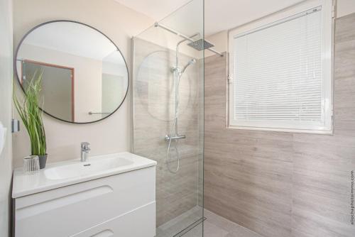a bathroom with a shower and a sink and a mirror at Villa Maorie 5 chambres avec piscine privée in Le François