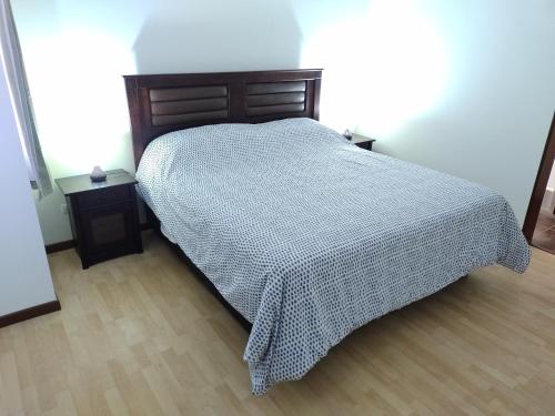 a bedroom with a bed with a checkered blanket at CASA PREMIUM Estadio Carlos Dittborn in Arica