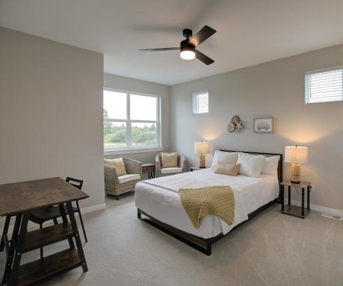 a bedroom with a bed and a chair and a table at Gone Coastal Oyhut Bay Seaside Village in Ocean Shores
