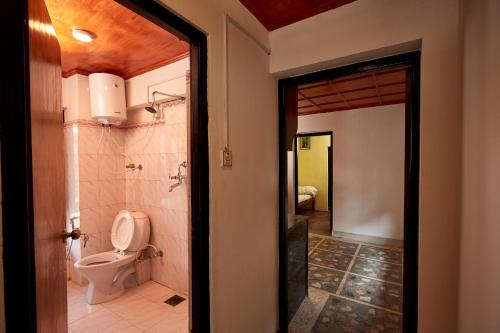 a bathroom with a toilet and a shower at Bandipur Bliss-Apartment in Bandipur