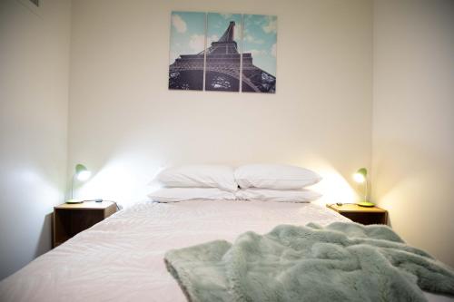 a bedroom with a bed with a blanket on it at Oceans 15 - Self-service Apartments in Whitianga