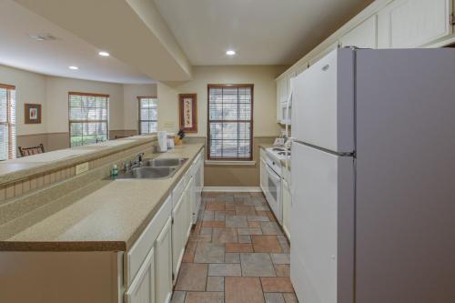 a kitchen with a white refrigerator and a sink at Holiday Inn Club Vacations Villages Resort at Lake Palestine in Flint