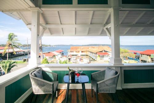 a table on a porch with a view of the ocean at Gran Hotel Bahia in Bocas Town