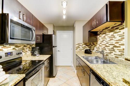 a kitchen with a sink and a microwave at Holiday Inn Club Vacations at Desert Club Resort in Las Vegas